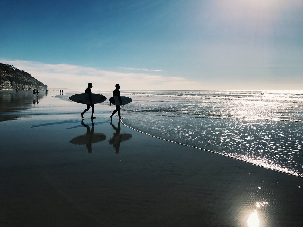 Two surfers on the beach in San Diego
