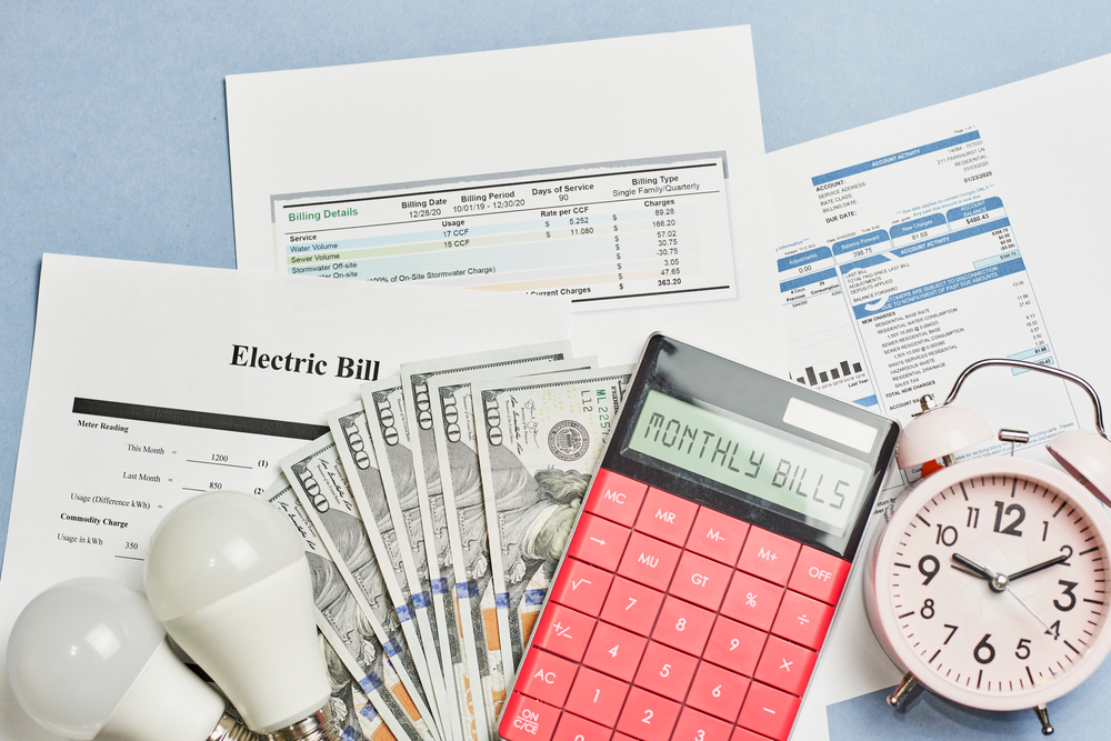 bills, cash, calculator, all sitting on top of table