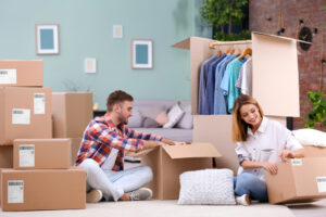Couple opening boxes and storing clothes