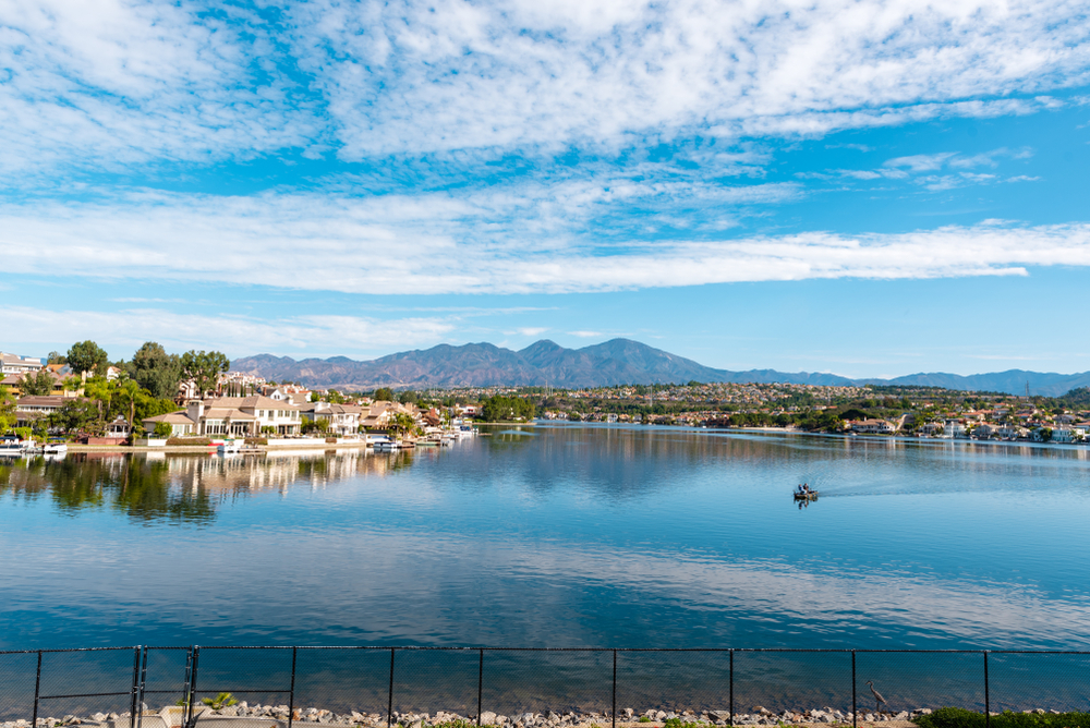 Lake Mission Viejo with houses on lake front and blue skies