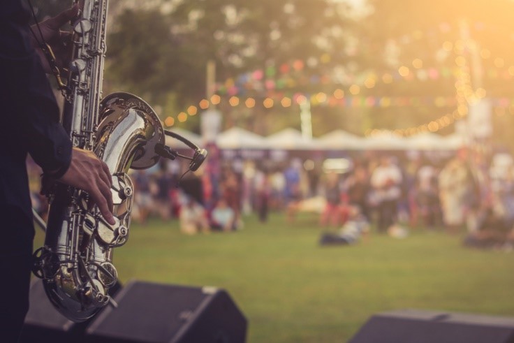 person playing saxophone for crowd