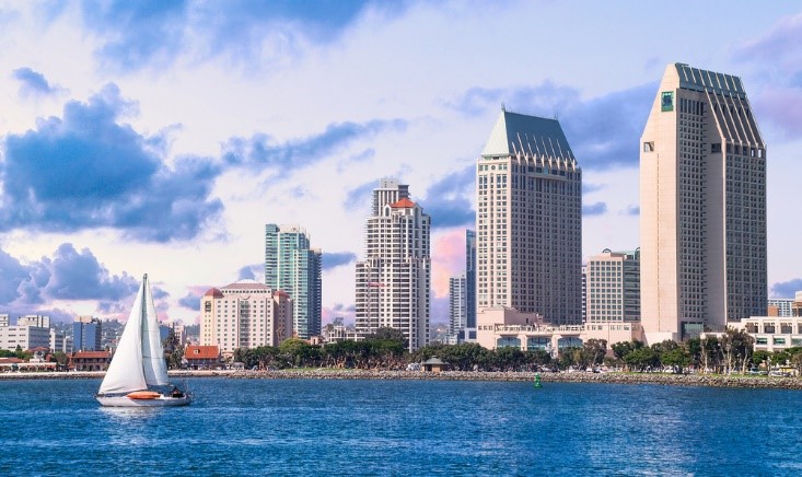 boat in ocean with skyscrapers in background