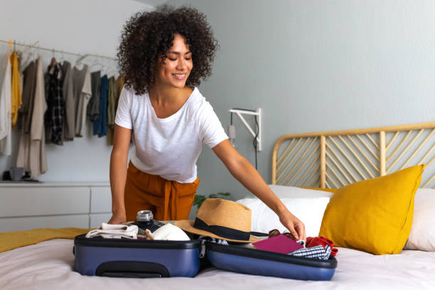 Women packing for a summer vacation. Women is looking to find storage solutions.
